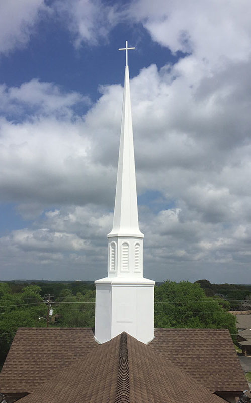 A newly coated white church tower
