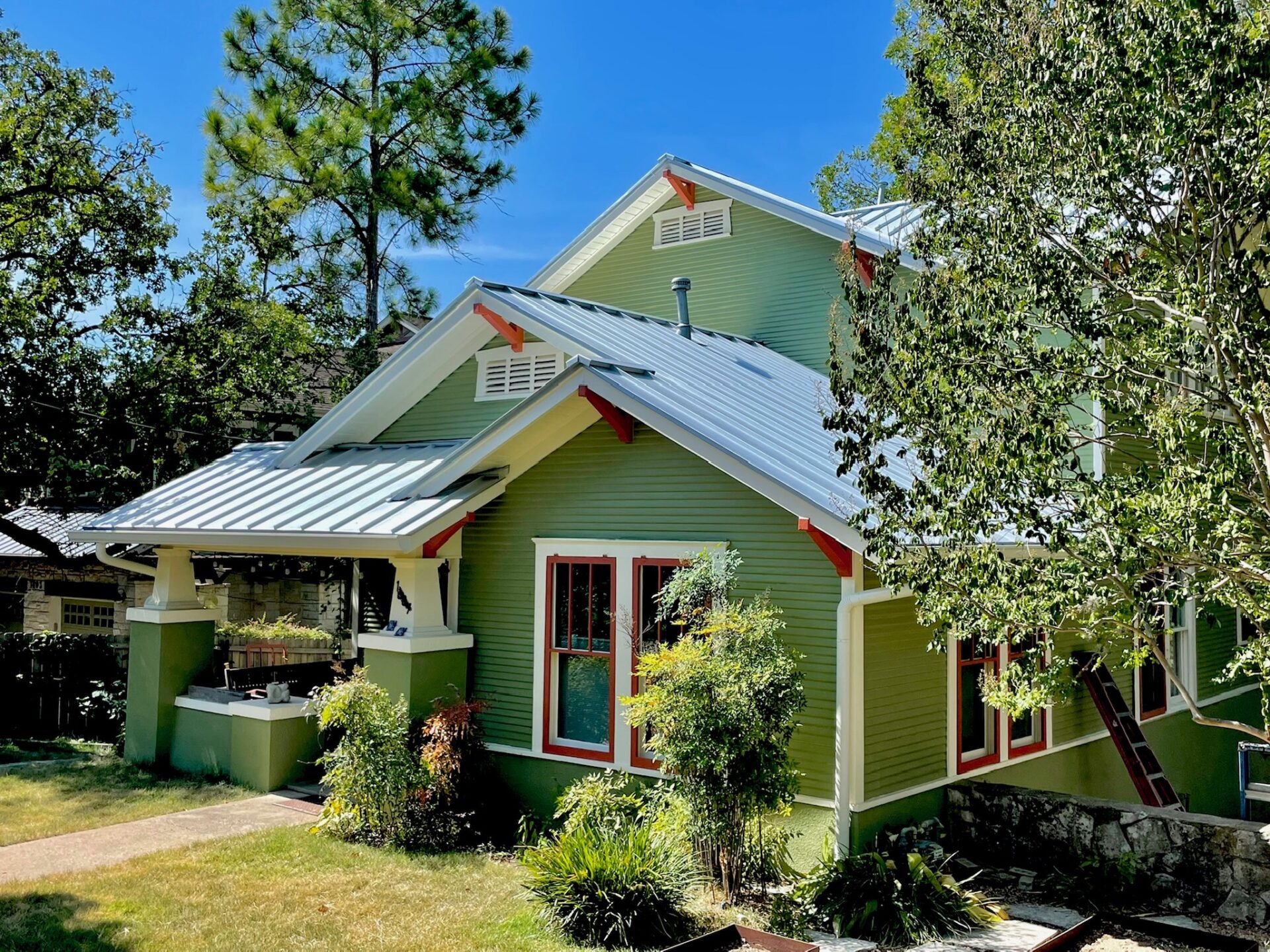 newly painted green-colored house with a  new metal roof