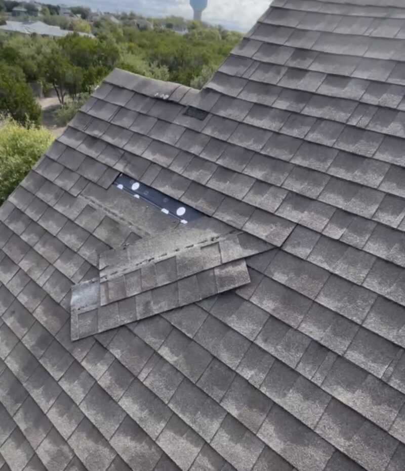 Storm damage asphalt shingle roof in Austin Texas afterhail and wind storm